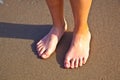 Feet of boy on the wet sand at the beach