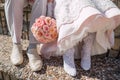 Feet of bride and groom, wedding shoes. A wedding bouquet from pink roses. Royalty Free Stock Photo