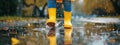 Feet of child in yellow rubber boots jumping over a puddle in the rain Royalty Free Stock Photo