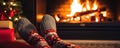 Feet Clad In Woollen Socks In Front Of A Christmas Fireplace A Woman Relaxes By The Warm Fire Warmin