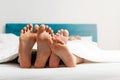 Feet close up of young loving couple enjoying on the bed Royalty Free Stock Photo