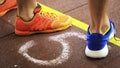 Feet in color sneakers on the floor