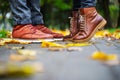 Feet of a couple in love in brown shoes