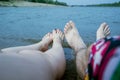 Feet of the couple, by the river, enjoy a beach holiday, buzz and relaxation Royalty Free Stock Photo