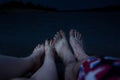 Feet of the couple, by the river, enjoy a beach holiday, buzz and relaxation Royalty Free Stock Photo