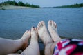 Feet of the couple, by the river, enjoy a beach holiday, buzz and relaxation Royalty Free Stock Photo