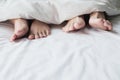 Feet of a couple sleeping side by side. Royalty Free Stock Photo