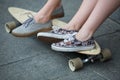 Feet couple of teenagers on the longboard closeup