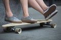 Feet couple of teenagers on the longboard closeup