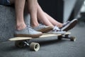 Feet couple of teenagers on the longboard closeup