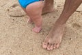 feet of dad and baby boy walking on the beach Royalty Free Stock Photo