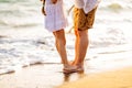 Feet of dad and daughter stand on sandy beach. family vacation at sea Royalty Free Stock Photo