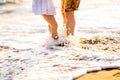 Feet of dad and daughter stand on sandy beach. family vacation at sea Royalty Free Stock Photo