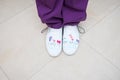 Feet of the dentist in shoes with pictures, the subject of dentistry. professional shoes