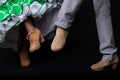 Feet detail of flamenco dancers on black background.