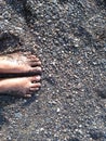 Feet exposed to fine sand on the beach, the sand is very beautiful