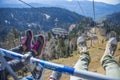 Feet of a family on a funicular on the background of the Caucasus mountains. Krasnaya Polyana - Alpine ski resort. Rosa