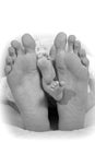 Feet of the father and feet of the newborn baby