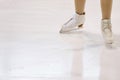 Feet of Figure Skater on Ice