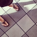 Feet, flip-flops and tiles