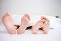 The feet or foot of couples sleeping on the bed Royalty Free Stock Photo