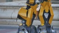 Feet of the foot of the yellow robot. Transformer robot terrible