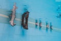 Feet of four women underwater