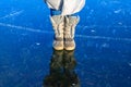 Feet on frozen ice, frozen river, thick ice Royalty Free Stock Photo