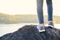 Feet girl standing on the rock in nature winter season Royalty Free Stock Photo