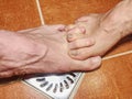 Feet of girlfriend and boyfriend in shower stall