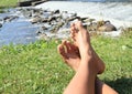 Feet on grass by weir Royalty Free Stock Photo