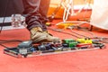 Feet of guitar player on a stage with set of distortion effect pedals. Royalty Free Stock Photo