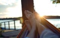 Feet in hammock at sunset Royalty Free Stock Photo