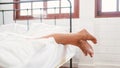 Feet of happy two friends Caucasian young women in white bathrobes lying on the bed at home. LGBTQ couples leisure spa. Royalty Free Stock Photo