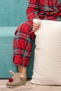 Feet in home pajamas and slippers. Young woman in slippers at home. Royalty Free Stock Photo