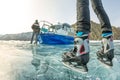 Feet in ice skates on ice and Baikal, hovercraft on an air cushion