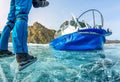 Feet in ice skates on ice and Baikal, hovercraft on an air cushion