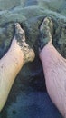 feet intertwined in the sand on the beach Royalty Free Stock Photo