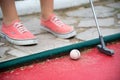 Feet of a kid playing mini golf Royalty Free Stock Photo