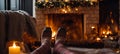 Feet in knitted socks against the background of a fireplace ?