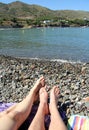 A feet and legs of a couple lying on a beach in Colera, Costa Brava, Girona province, Catalonia, Spain