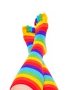 Feet and legs in striped rainbow socks Royalty Free Stock Photo