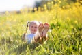 Feet of little girl in yellow field with flowers