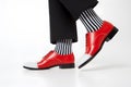 Feet of man with bright red shoes and funny socks on white background Royalty Free Stock Photo