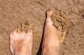 Feet of a man in dirty clay