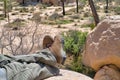 Feet of man resting on huge rocks at Joshua Tree National Park California Royalty Free Stock Photo