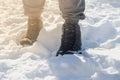 The feet of a man in winter warm shoes on the snow in a frosty winter Royalty Free Stock Photo