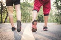 Feet man and woman running on the road for health Royalty Free Stock Photo