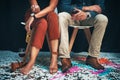 Feet, man and woman sitting at a party to celebrate new years eve and socialise together. Legs, couple and celebrating Royalty Free Stock Photo