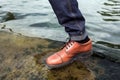 Feet of Men in selvedge jeans and retro shoes Royalty Free Stock Photo